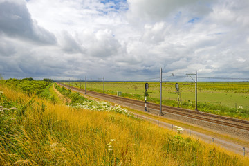 Railroad through a sunny landscape in summer