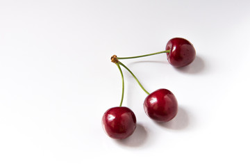 Bowl of red fresh cerries on a white background