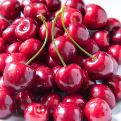 Bowl of red fresh cerries on a white background