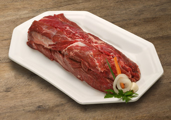 Raw meat selection on wooden cutting board with knife