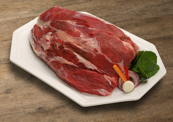 Raw meat selection on wooden cutting board with knife