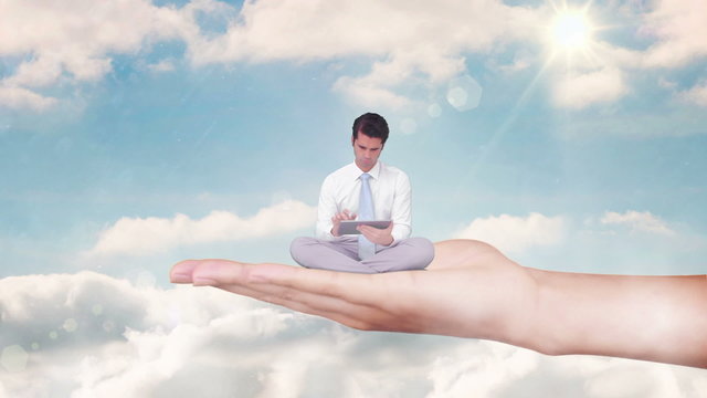 Hand holding sitting businessman using tablet