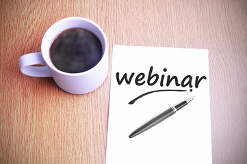 Coffee on the table with note writing webinar