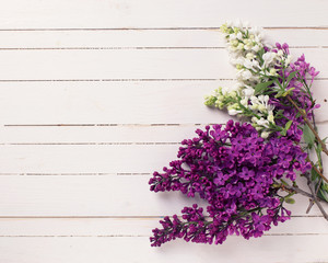 Lilac flowers on wooden background.