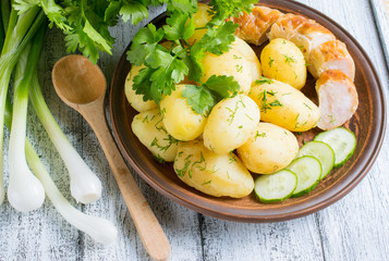 Young boiled potatoes with dill, sausage, cucumber, parsley and