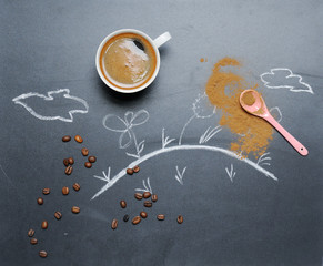 Fototapeta na wymiar mug of coffee with happy drawing on the blackboard from the top