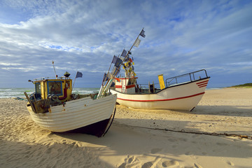 Naklejka na ściany i meble Small fishing boat, on the beach, of Baltic sea, Poland