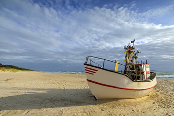 Naklejka na ściany i meble Small fishing boat, on the beach, of Baltic sea, Poland