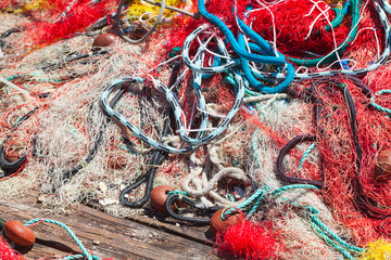 Colorful fishing net laying on wooden pier