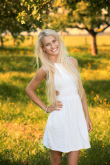 Happy young woman on a summer flower meadow outdoor