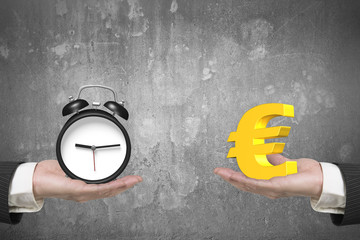 Euro symbol and alarm clock with two hands