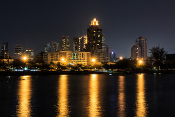 City Downtown at Night with Building Reflection in the River.