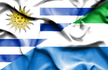 Waving flag of Sierra Leone and Uruguay