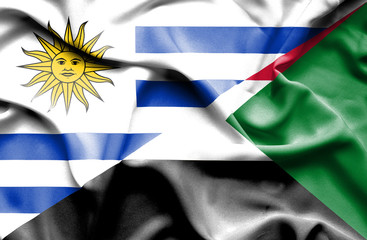 Waving flag of Sudan and Uruguay
