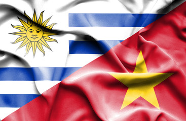 Waving flag of Vietnam and Uruguay