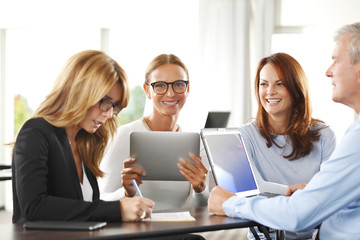 Business people. Businesswoman and businessman working together on laptop at office