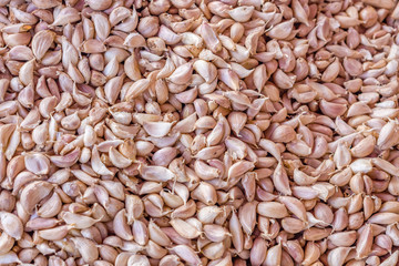 Heap of garlic or Allium sativum cloves for retail sale 