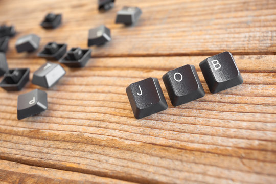 "JOB" wrote with keyboard keys on wooden background