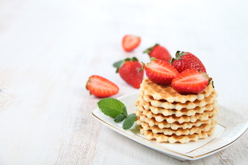 Waffles and ripe strawberries.