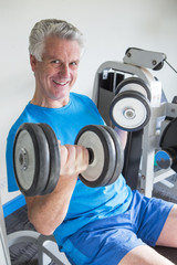 Fototapeta na wymiar Senior man with weights