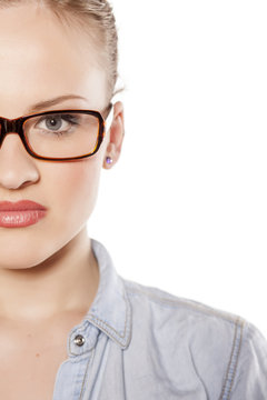 half portrait of young blonde with glasses on a white background