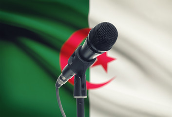Microphone on stand with national flag on background - Algeria
