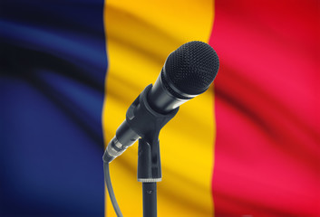 Microphone on stand with national flag on background - Chad