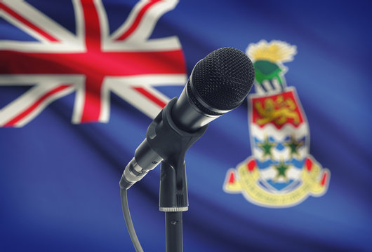 Microphone on stand with national flag on background - Cayman Islands