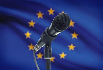 Microphone on stand with national flag on background - European Union - EU