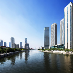modern buildings in urban city at riverbank