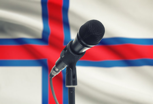 Microphone on stand with national flag on background - Faroe Islands