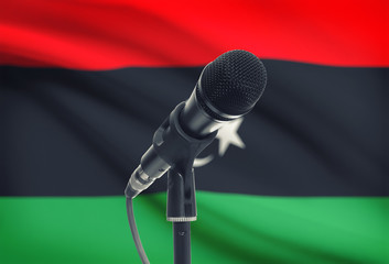 Microphone on stand with national flag on background - Libya