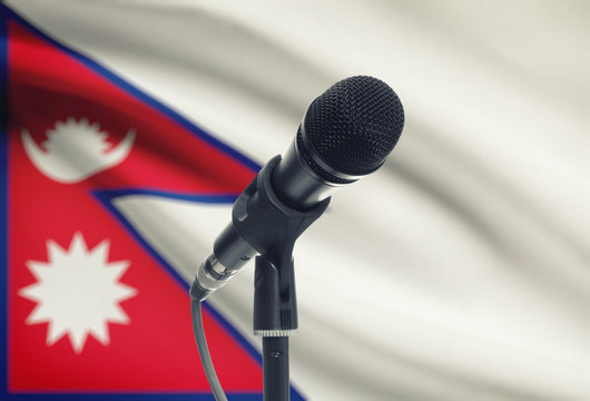 Microphone on stand with national flag on background - Nepal