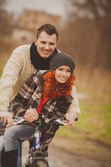 Happy young couple embracing and having fun together outdoors in autumn 