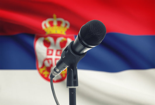 Microphone on stand with national flag on background - Serbia