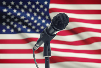 Microphone on stand with national flag on background - United States