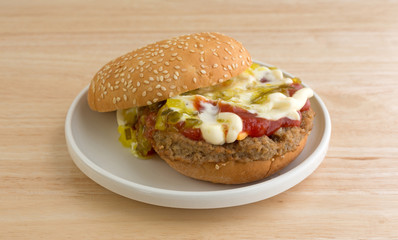 Cheeseburger with bun and condiments on small plate