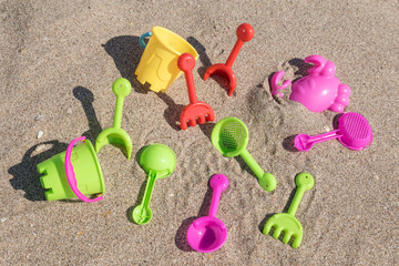 Fototapeta na wymiar colorful shovels and spade for children on beach