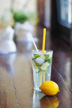 Still life with refreshing lemonade with lemon, mint and ginger inside