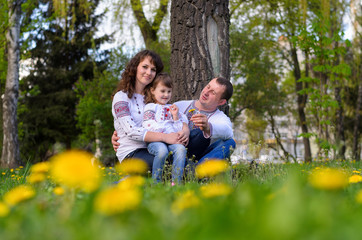 Fototapeta premium happy Ukrainian family dad mother and daughter on nature