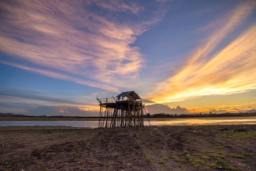 Abandon wooden fisherman hut in beautiful sunset scene