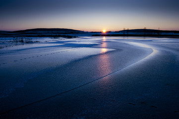 sunset on frozen lake