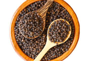 black pepper on wooden spoon with wooden plate isolated on white background.