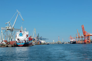 Port of Gdynia with cranes, gantrys and ships at piers, Poland