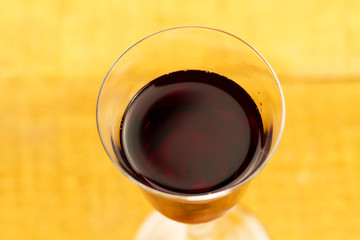 glass of red wine on wooden background, close up. Top view