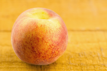 ripe fresh peaches on wooden background