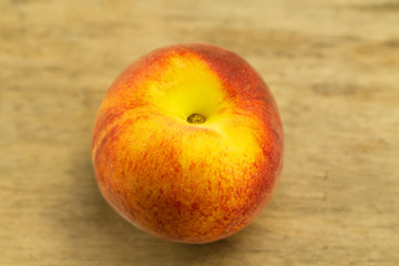 ripe fresh peaches on wooden background