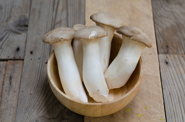 King oyster mushroom Pleurotus eryngii in wooden bowl