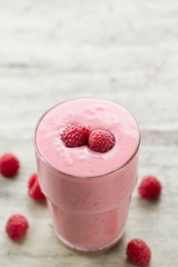 Raspberry and blueberry smoothie with berries on wooden background. Healthy vegetarian food, diet.