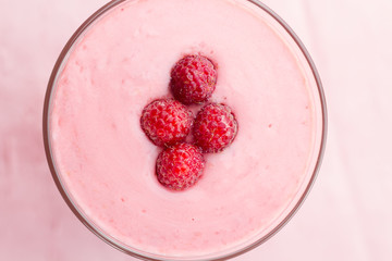Raspberry smoothie with berries on wooden background. Healthy vegetarian food, diet.